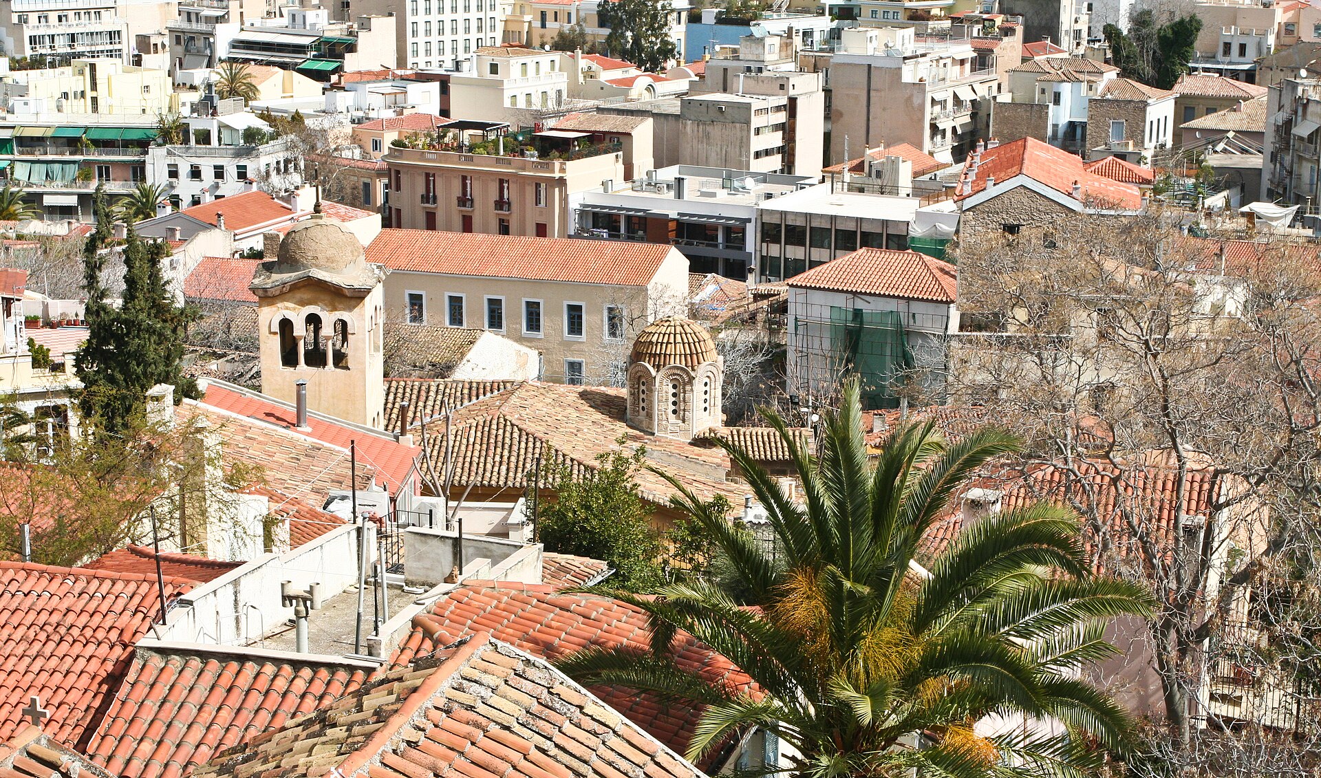 Athens rooftops and dense central buildings seen from above.